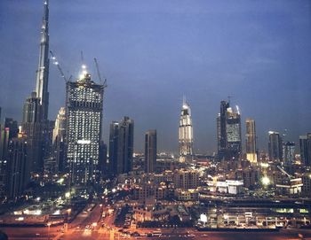 View of skyscrapers lit up at night