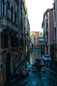 Boats in canal with buildings in background