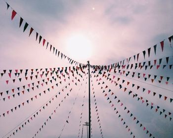 Low angle view of decorations hanging against sky