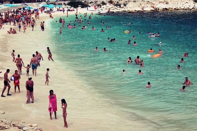 High angle view of people enjoying at beach