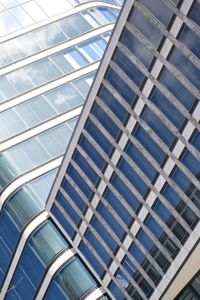 Low angle view of modern glass building in city