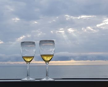 Drink in glass against sea and sky