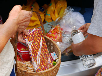 Thais preparing stuff from the back of their car for rod nam dam hua ceremony