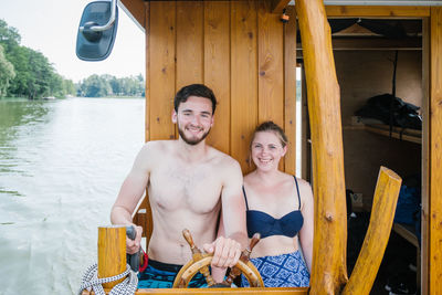 Couple sitting in boat over river