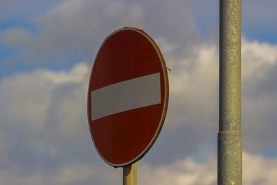 Low angle view of road sign against sky