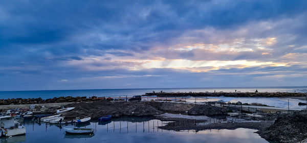 Panoramic view of beach against sky during sunset