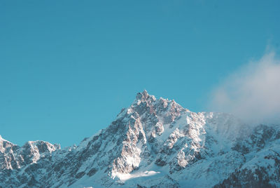 Scenic view of snow covered mountains against clear sky