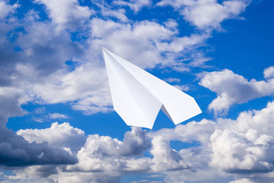 Low angle view of paper flag against blue sky