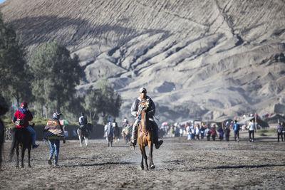 People riding horses on field