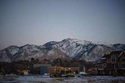 Snow covered mountains against clear sky