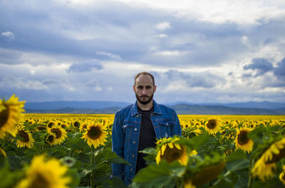 Woman standing in sunflower field