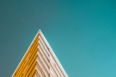 Low angle view of modern building against clear blue sky