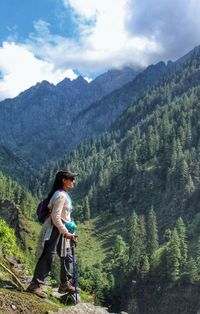 Man looking at mountain range against sky