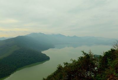 Scenic view of lake and mountains against sky