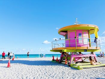 Lifeguard hut on beach against clear blue sky