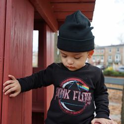 Full length of cute boy standing against wall