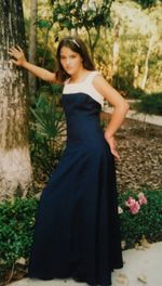 Young woman standing against tree