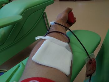 Cropped hand of man with bandage in hospital