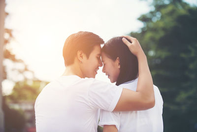 Happy young couple sitting in public park