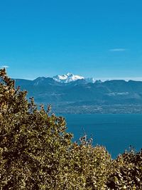 Scenic view of mountains against clear blue sky