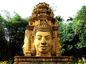 Low angle view of statue against trees