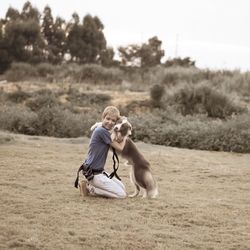 Rear view of man and woman with dog