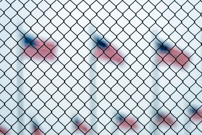 Close-up of heart shape on chainlink fence