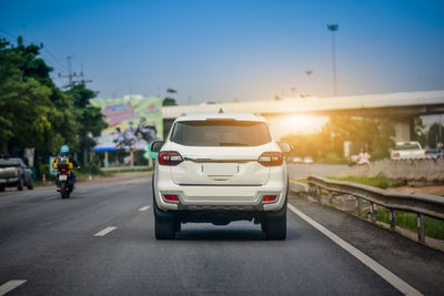 Cars on road at sunset