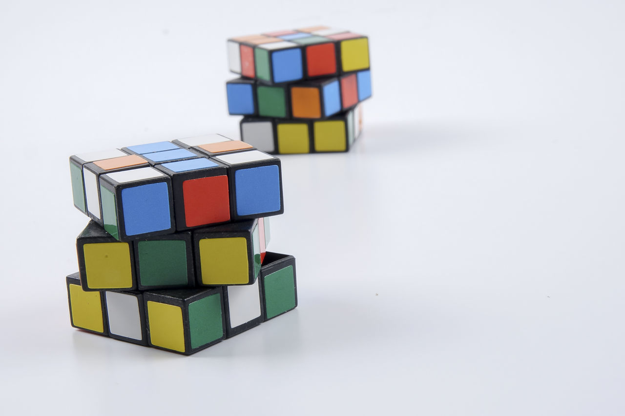 CLOSE-UP OF MULTI COLORED TOY ON TABLE