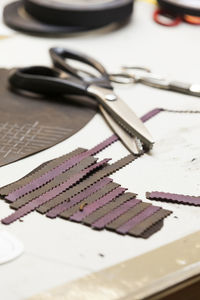 High angle view of scissors with textile on table