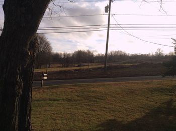 Scenic view of field against cloudy sky