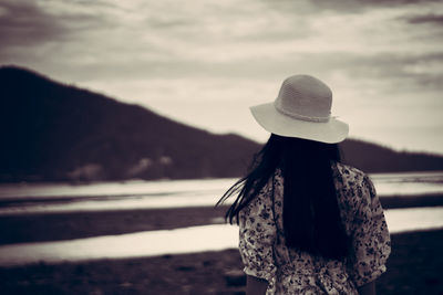 Rear view of woman looking at camera