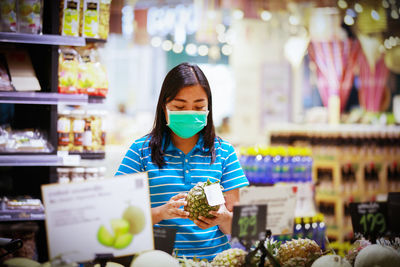 Woman holding ice cream at store