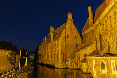 Panoramic view of illuminated building against sky at night