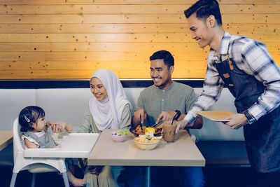 People sitting at restaurant table