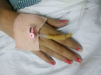 Close-up of woman hand with iv drip at hospital