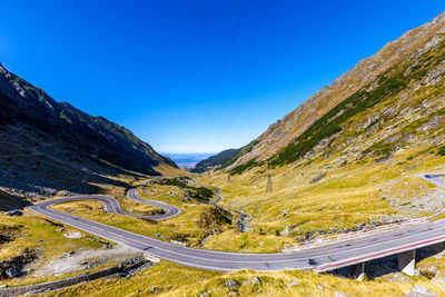 Scenic view of mountains against blue sky