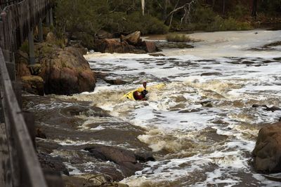 High angle view of river flowing amidst rocks