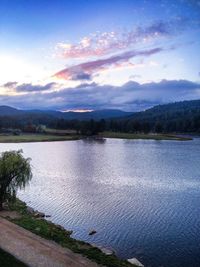 Scenic view of lake against cloudy sky