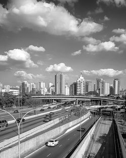 Panoramic view of city street and buildings against sky