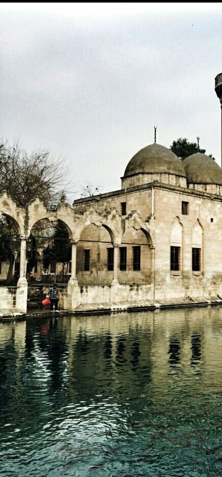 architecture, built structure, building exterior, water, waterfront, sky, tree, history, clear sky, facade, day, reflection, house, arch, outdoors, river, building, residential building, dome, old