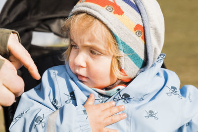 Close-up of cute girl looking away during winter