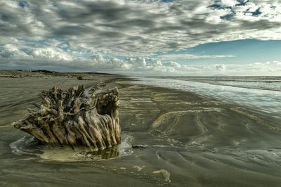 Scenic view of sea against cloudy sky