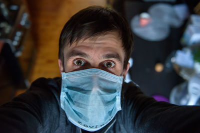 Close-up portrait of man wearing mask