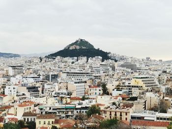 Buildings in town against sky