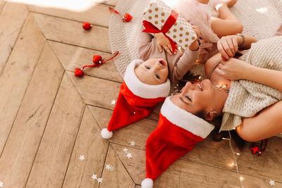 High angle view of friends lying on floor