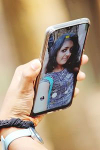 Midsection of woman using mobile phone