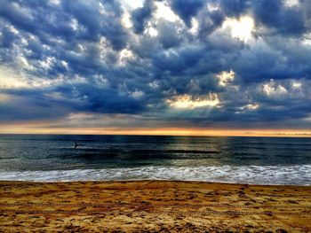 Scenic view of sea against cloudy sky