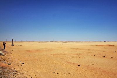 Scenic view of beach against clear blue sky