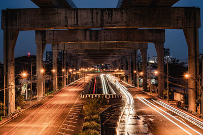 Light trails on bridge in city at night